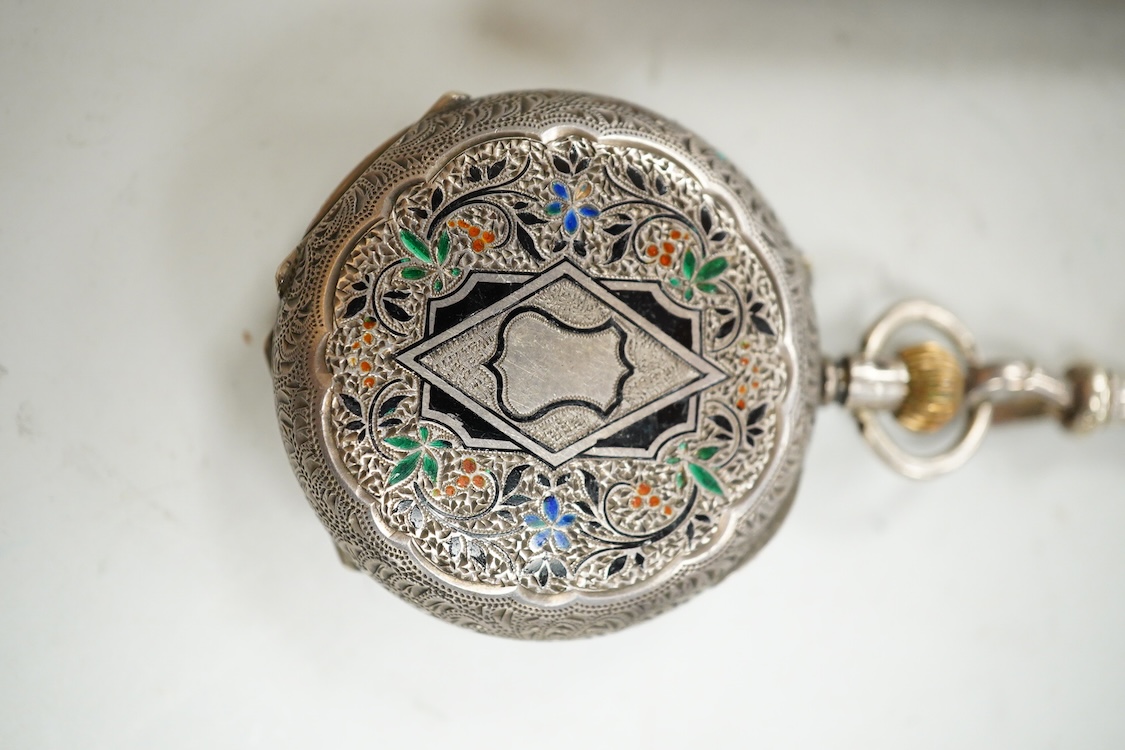 An Edwardian pierced silver chatelaine, by Samuel Jacob, London, 1902, with three accoutrements to include two silver cases and a enamelled fob watch, overall length 34cm.